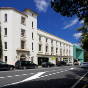 Te Uru Waitakere is a new art gallery architecture, building, car, city, downtown, estate, facade, family car, home, house, infrastructure, luxury vehicle, metropolitan area, mixed use, neighbourhood, property, real estate, residential area, road, sky, street, town, black