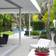 Sculpted furniture is in keeping with the Mid-century architecture, condominium, courtyard, home, house, interior design, plant, real estate, gray