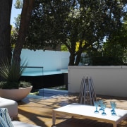 Mature trees provide dappled shade to the patio backyard, furniture, home, house, interior design, outdoor furniture, outdoor structure, patio, plant, swimming pool, table, tree, black