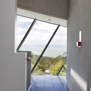 A large curtain wall on one side of apartment, architecture, daylighting, glass, home, house, interior design, property, window, gray