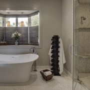 Textural white rock features on the floor of bathroom, floor, flooring, home, interior design, plumbing fixture, room, tile, window, gray