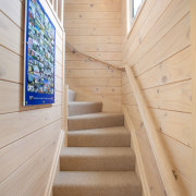 This two-storey Lockwood beach house features solid blonded apartment, architecture, ceiling, daylighting, floor, flooring, handrail, home, house, interior design, lobby, real estate, stairs, wall, wood, gray, orange