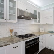 The ventilation unit in this kitchen was custom cabinetry, countertop, cuisine classique, floor, flooring, hardwood, home appliance, interior design, kitchen, kitchen appliance, kitchen stove, major appliance, room, tile, wood flooring, gray