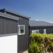 This new Christchurch house is a composition of architecture, building, cottage, facade, home, house, property, real estate, roof, shed, siding, window