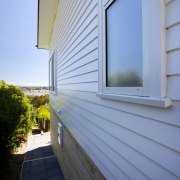 Palliside is a low-maintenance cladding solution that never architecture, building, daylighting, facade, home, house, real estate, residential area, roof, siding, sky, window, wood, teal