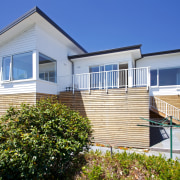 This new Christchurch house features Palliside low-maintenance weatherboards cottage, elevation, estate, facade, home, house, property, real estate, residential area, siding, sky, villa, window, blue