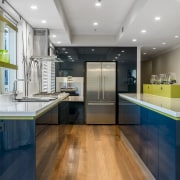 This two-tone design celebrates connections and contrast. The cabinetry, ceiling, countertop, floor, flooring, hardwood, house, interior design, kitchen, real estate, room, wood flooring, gray