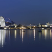 With its illuminated dome and ribbons of lights, city, cityscape, evening, landmark, metropolis, night, opera, reflection, sky, skyline, structure, tourism, tourist attraction, water, blue