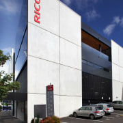 An extension at the rear of the Ricoh architecture, building, commercial building, corporate headquarters, daytime, facade, headquarters, metropolitan area, real estate, sky, blue, white