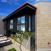 Indoor-outdoor living in this high-end townhouse designed by architecture, cottage, facade, home, house, property, real estate, siding, window, gray