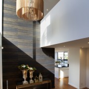 Entry to contemporary Parnell townhouse designed by Paul apartment, architecture, ceiling, daylighting, dining room, floor, hardwood, home, house, interior design, light fixture, lighting, living room, lobby, loft, gray