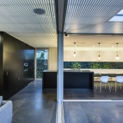 With large sliding glass doors wrapping around an architecture, ceiling, daylighting, house, interior design, lobby, real estate