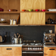 Gaboon shelving in this new holiday home contrasts cabinetry, countertop, cuisine classique, interior design, kitchen, kitchen organizer, wood, brown, orange