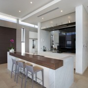 This kitchen, designed by Leon House, reinforces the ceiling, countertop, floor, flooring, interior design, kitchen, real estate, table, gray
