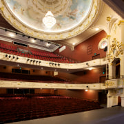 Custom chandeliers at the Isaac Theatre Royal were auditorium, ceiling, concert hall, opera house, performing arts center, theatre, orange, brown, red