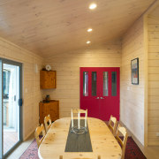 This new Lockwood, built by Lockwood Canterbury, is architecture, ceiling, dining room, floor, flooring, hardwood, home, house, interior design, living room, real estate, room, table, wall, wood, wood flooring, orange, brown