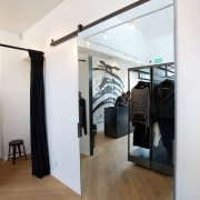 Soaring ceilings and skylights create light, airy store door, floor, flooring, interior design, loft, room, wood, white