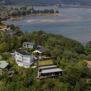 Hidden from the street above, the holiday home aerial photography, bay, bird's eye view, city, cloud, coast, highland, hill, hill station, house, lake, landscape, loch, mountain, real estate, reservoir, river, sea, sky, suburb, tree, water, brown, gray