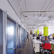 Full-height metal-wrapped pivoting doors allow sightlines through the ceiling, daylighting, interior design, office, gray