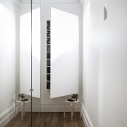 A tall cabinet is tucked away at one architecture, ceiling, daylighting, floor, interior design, white