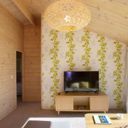 The new Lockwood show home features a decorative architecture, ceiling, house, interior design, living room, room, table, wall, orange, brown