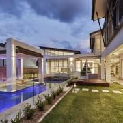 This house, by Starr Constructions, features a large apartment, architecture, condominium, estate, home, house, interior design, mixed use, property, real estate, residential area, swimming pool, villa