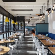Upholstered banquette seating reinforces the cruise ship analogy interior design, restaurant, gray, black