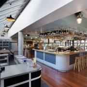 Lowered bulkheads with painted tongue-and-groove boards define The interior design, restaurant, gray