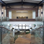 A twisting central staircase provides a dramatic centrepiece daylighting, floor, flooring, glass, interior design, wood, gray