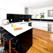 Back-painted black glass and white high-gloss acrylic with countertop, floor, hardwood, interior design, kitchen, real estate, room, wood flooring, white