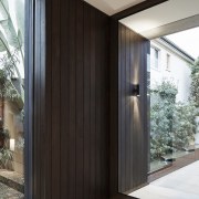 Repositioning the front door to the middle at architecture, door, facade, house, wood, black, gray