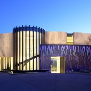 Dramatic entrance  a gently curving wall of architecture, building, corporate headquarters, estate, facade, home, house, lighting, property, real estate, tourist attraction, blue