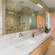 Handleless wall cabinetry provides unobtrusive storage in this bathroom, home, interior design, real estate, room, tile, gray
