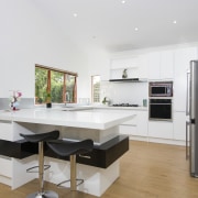 This crisp, contemporary white kitchen was designed and countertop, interior design, kitchen, room, white