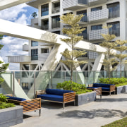 Landscaping and seating on the level 26 sky apartment, architecture, condominium, courtyard, home, mixed use, outdoor structure, plant, property, real estate, residential area, tree, white, gray