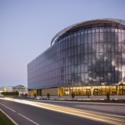 The Canberra Airport Hotel is a giant landmark architecture, building, commercial building, corporate headquarters, daytime, facade, headquarters, metropolis, metropolitan area, mixed use, sky, urban area, teal