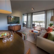 This living space and deck at Figtree Apartments interior design, living room, penthouse apartment, real estate, room, suite, gray