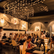 Tokyo Bay restaurant has tiered dining areas and café, interior design, restaurant, black, brown, orange