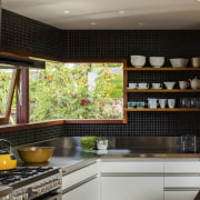 A frameless corner window helps this kitchen niche cabinetry, countertop, interior design, kitchen, under cabinet lighting, black