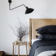 Bedside table and lighting in an apartment master floor, furniture, interior design, lamp, lampshade, light fixture, lighting, lighting accessory, product design, table, wall, white