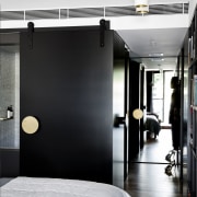 This black sliding wall panel can open up floor, furniture, interior design, room, black, white