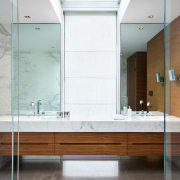 The window between these two vanity basins is bathroom, bathroom accessory, bathroom cabinet, interior design, room, sink, white, brown, gray