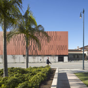 Copper-coloured concrete forms reminiscent of envelopes clad the architecture, building, campus, corporate headquarters, daytime, facade, neighbourhood, plaza, real estate, sky, teal