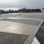 A traffic circle near Hamilton airport benefits from asphalt, lane, road, road surface, gray