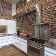 L shapes are a design feature of this brick, countertop, fireplace, flooring, hearth, interior design, kitchen, real estate, tile, wood flooring, brown