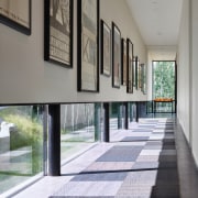 This passageway in the guest wing of a architecture, floor, flooring, house, interior design, real estate, window, gray