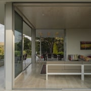 Indoor-outdoor flow is central to this home renovation. architecture, door, house, interior design, property, real estate, window, gray, black