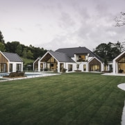 On this home, the crisp lines of the cottage, estate, facade, farmhouse, grass, home, house, landscape, lawn, property, real estate, residential area, siding, suburb, villa, white