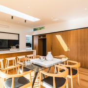 The wall of cabinetry alongside this kitchen is dining room, interior design, real estate, room, table, white, orange