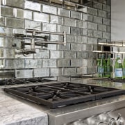 Hefty appliances meet chunky countertops in this upmarket countertop, interior design, tile, wall, gray, black